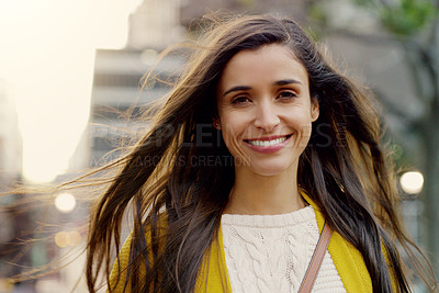 Buy stock photo Portrait of a young woman smiling and in good spirits in the city