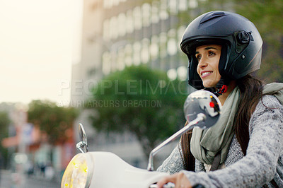 Buy stock photo Shot of an attractive young woman riding her scooter through the city
