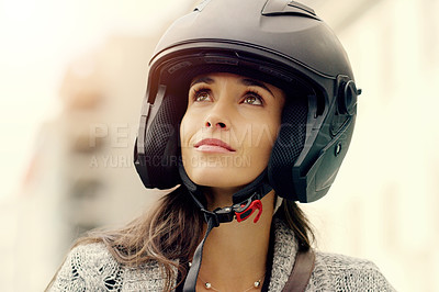 Buy stock photo Closeup shot of an attractive young woman wearing a helmet and riding her scooter through the city