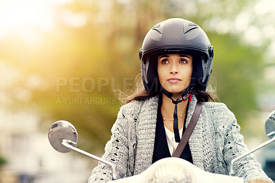 Buy stock photo Shot of an attractive young woman riding her scooter through the city