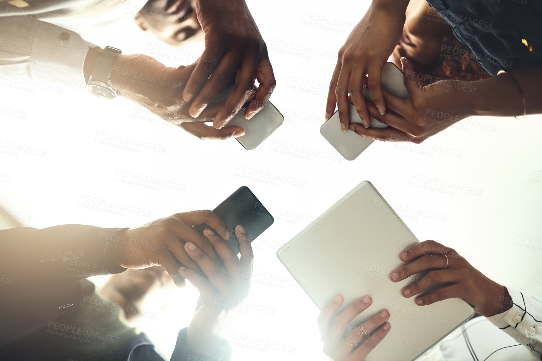 Buy stock photo Employees, hands and tech in workplace circle, campaign project and research media trend. Staff, low angle and meeting for feedback on audience engagement, online and connect for plan in office