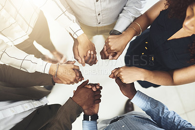 Buy stock photo Business people, above and holding hands in circle at office for teamwork, support and solidarity. Company, partnership and employees with gesture of trust for collaboration, agreement and motivation