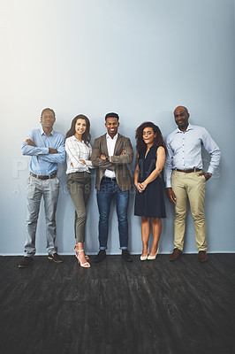 Buy stock photo Studio shot of a group of businesspeople standing together against a gray background