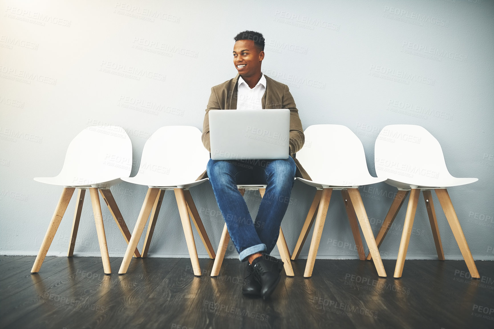 Buy stock photo Studio shot of a young businessman using a laptop while waiting against a gray background