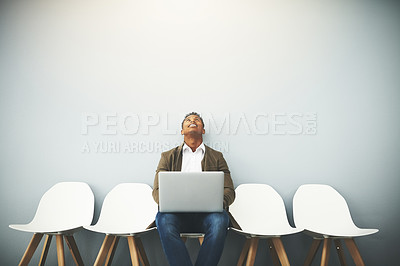 Buy stock photo Man, laptop and queue for interview by wall, thinking or mockup space for opportunity in office. African person, computer and line with smile, human resource or onboarding with recruitment at agency