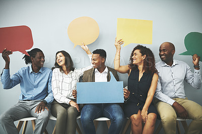 Buy stock photo Studio shot of a group of businesspeople holding colorful speech bubbles in line against a gray background