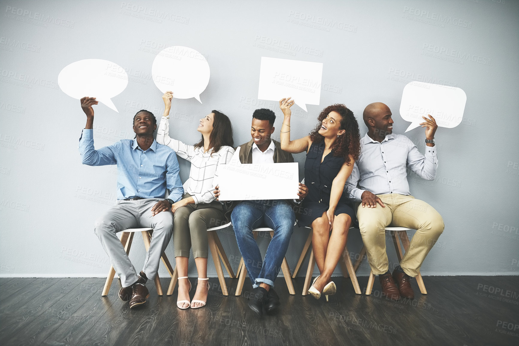 Buy stock photo Studio shot of a group of businesspeople holding speech bubbles in line against a gray background