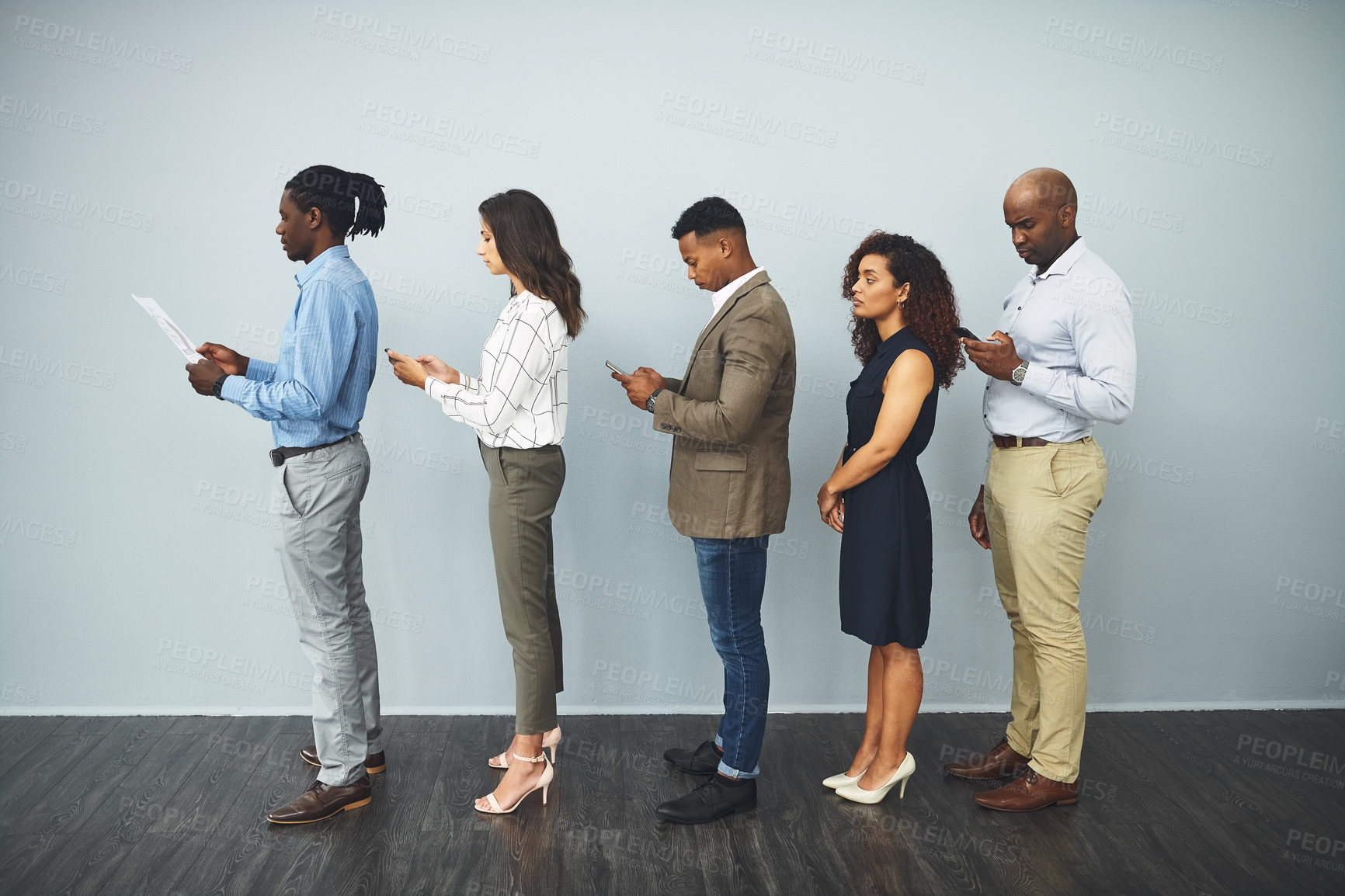 Buy stock photo Office, technology and row of business people for interview, recruitment or patience for corporate career. Diversity, men and women as candidates with smartphone, document or waiting queue for hiring