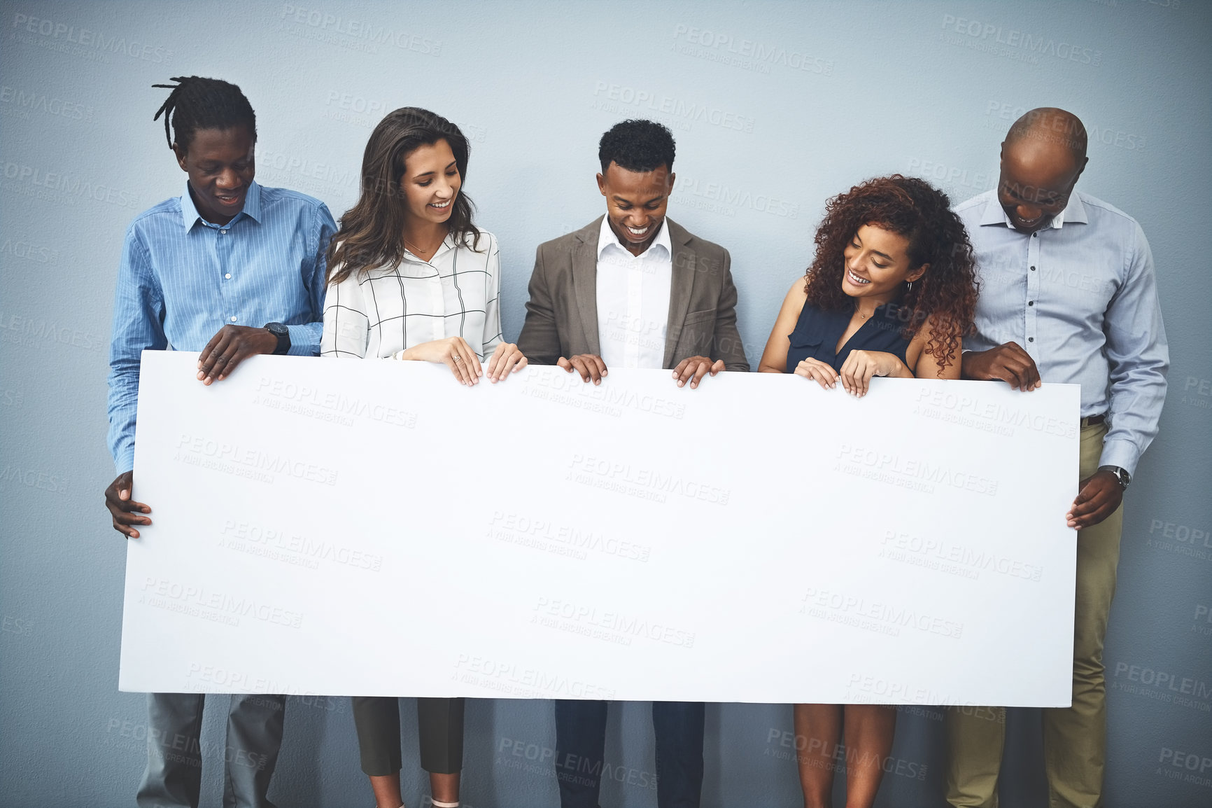 Buy stock photo Business, people and smile with poster in studio on gray background for recruitment advertisement on mockup space. Professional, diversity employees or empty sign for company announcement or about us