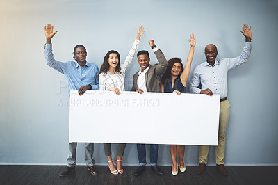 Buy stock photo Studio shot of a group of businesspeople holding a sign and cheering against a gray background