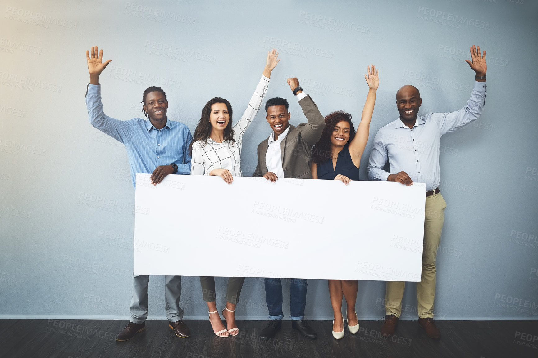 Buy stock photo Studio shot of a group of businesspeople holding a sign and cheering against a gray background