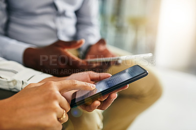Buy stock photo Closeup shot of two businesspeople using digital devices in synchronicity in an office