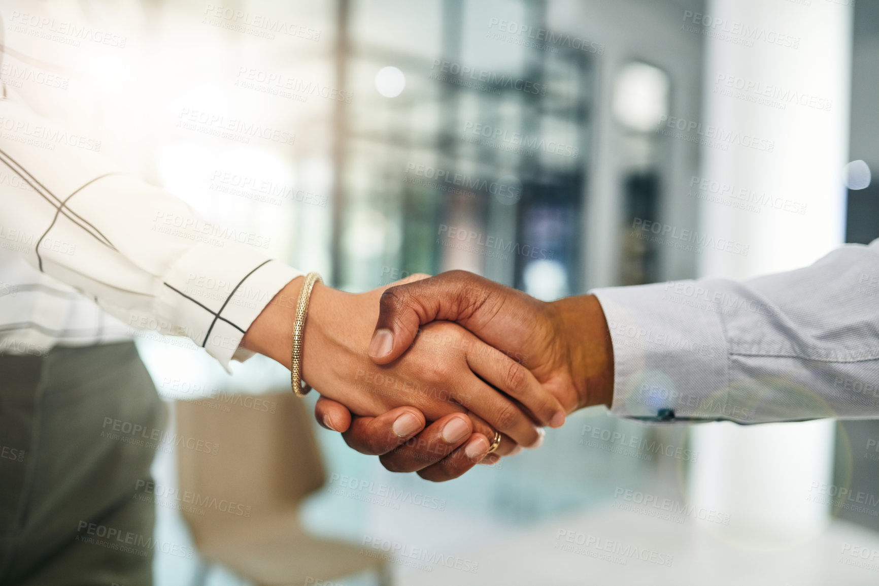 Buy stock photo Closeup shot of two businesspeople shaking hands in an office