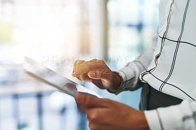 Buy stock photo Closeup shot of an unrecognizable businesswoman using a digital tablet in an office