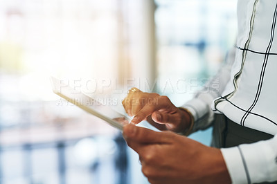 Buy stock photo Closeup shot of an unrecognizable businesswoman using a digital tablet in an office