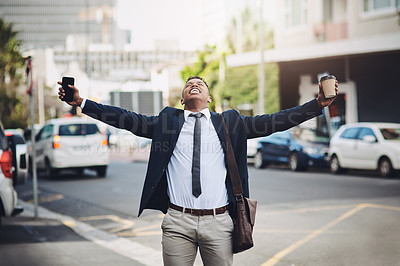 Buy stock photo Shot of a happy young businessman standing with his arms outstretched in the city
