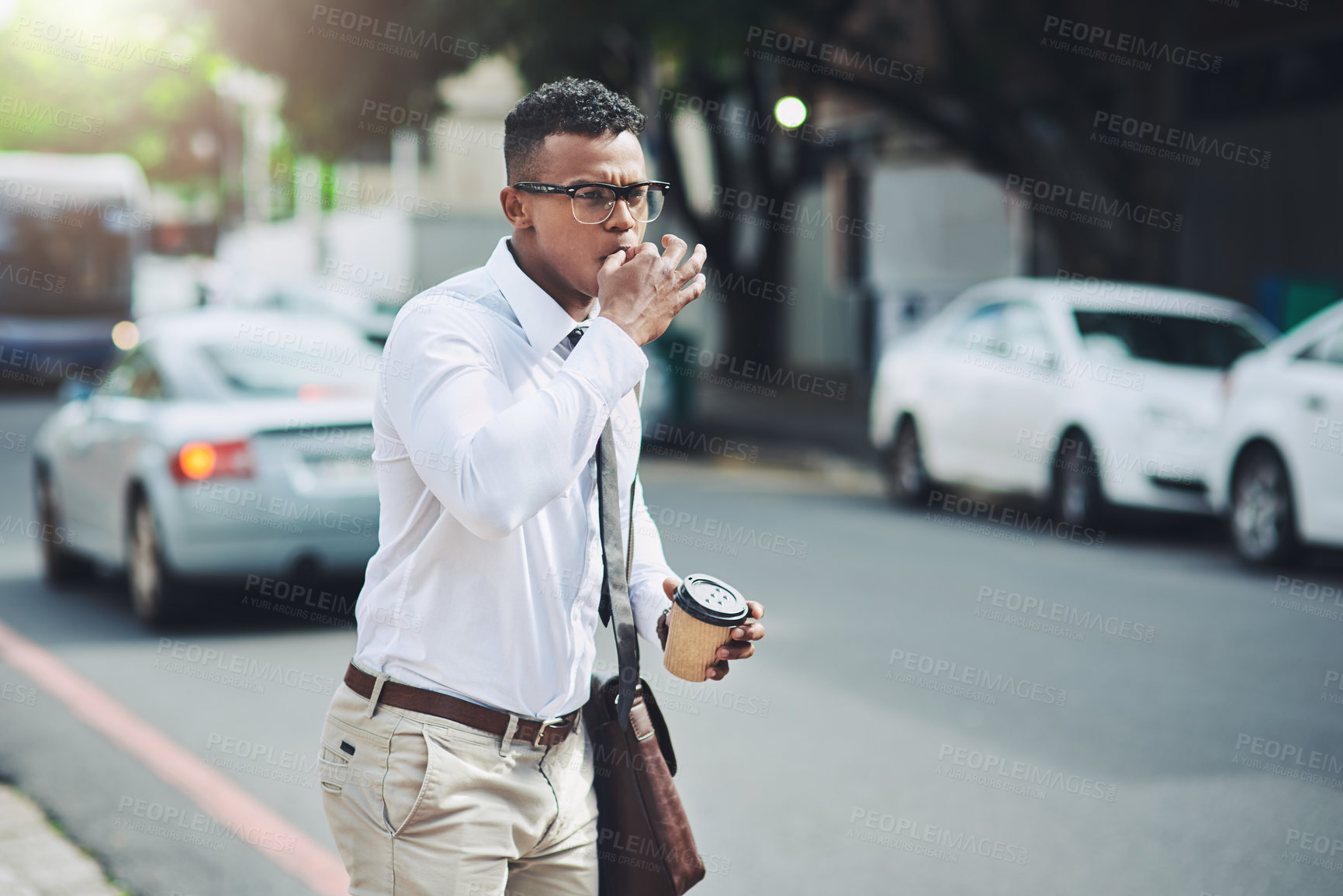 Buy stock photo Shot of a young businessman whistling to get a cab in the city