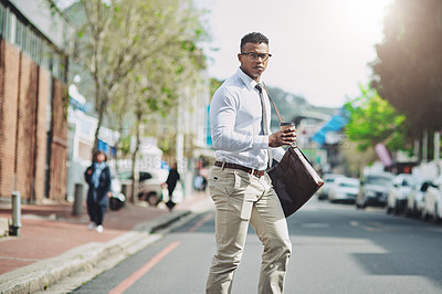 Buy stock photo Shot of a handsome young businessman in the city