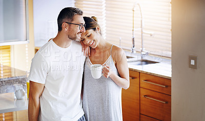 Buy stock photo Love, tea and couple hug in a kitchen for morning, conversation and bonding at home together. Marriage, trust and people embrace with coffee in house for speaking, security and romance on weekend