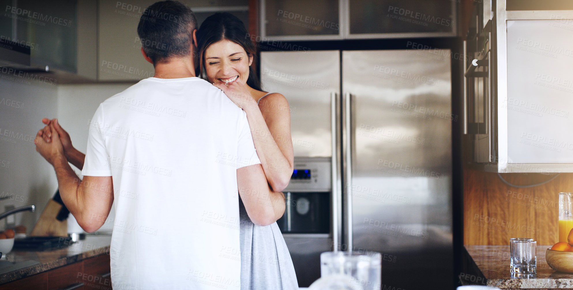 Buy stock photo Music, love and happy couple dance in kitchen with romantic, celebration or anniversary at home. Radio, hug and people moving to audio in a house with morning bonding, support or having fun together