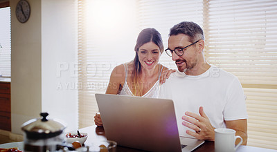 Buy stock photo Shot of a mature couple using a laptop together at home