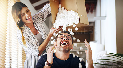 Buy stock photo Moving house, property and box with a silly married couple having fun while playing in their new home together. Real estate, comic or comedy with a playful husband and wife joking in the living room