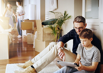 Buy stock photo Man, boy and tablet, playing games and relax, break from unpacking and moving into new house. Father, son and wireless tech with property, real estate and rest with video game online and bonding