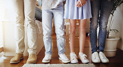 Buy stock photo Love, family and closeup of people with shoes standing in a line in the living room of their home. Bonding, together and zoom of couple and children legs in a row in the lounge of their modern house.
