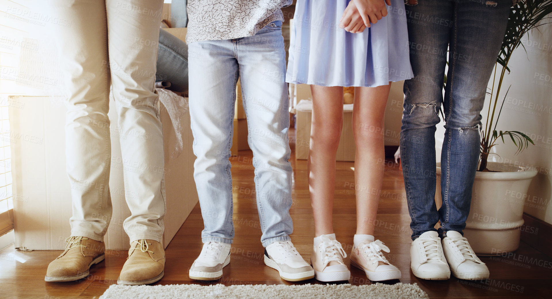 Buy stock photo Love, family and closeup of people with shoes standing in a line in the living room of their home. Bonding, together and zoom of couple and children legs in a row in the lounge of their modern house.