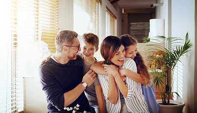 Buy stock photo Happy, love and family in their new home, moving and loving with embrace, laughing and cheerful together. Parents, mother and father with kids, children and siblings in an apartment and milestone