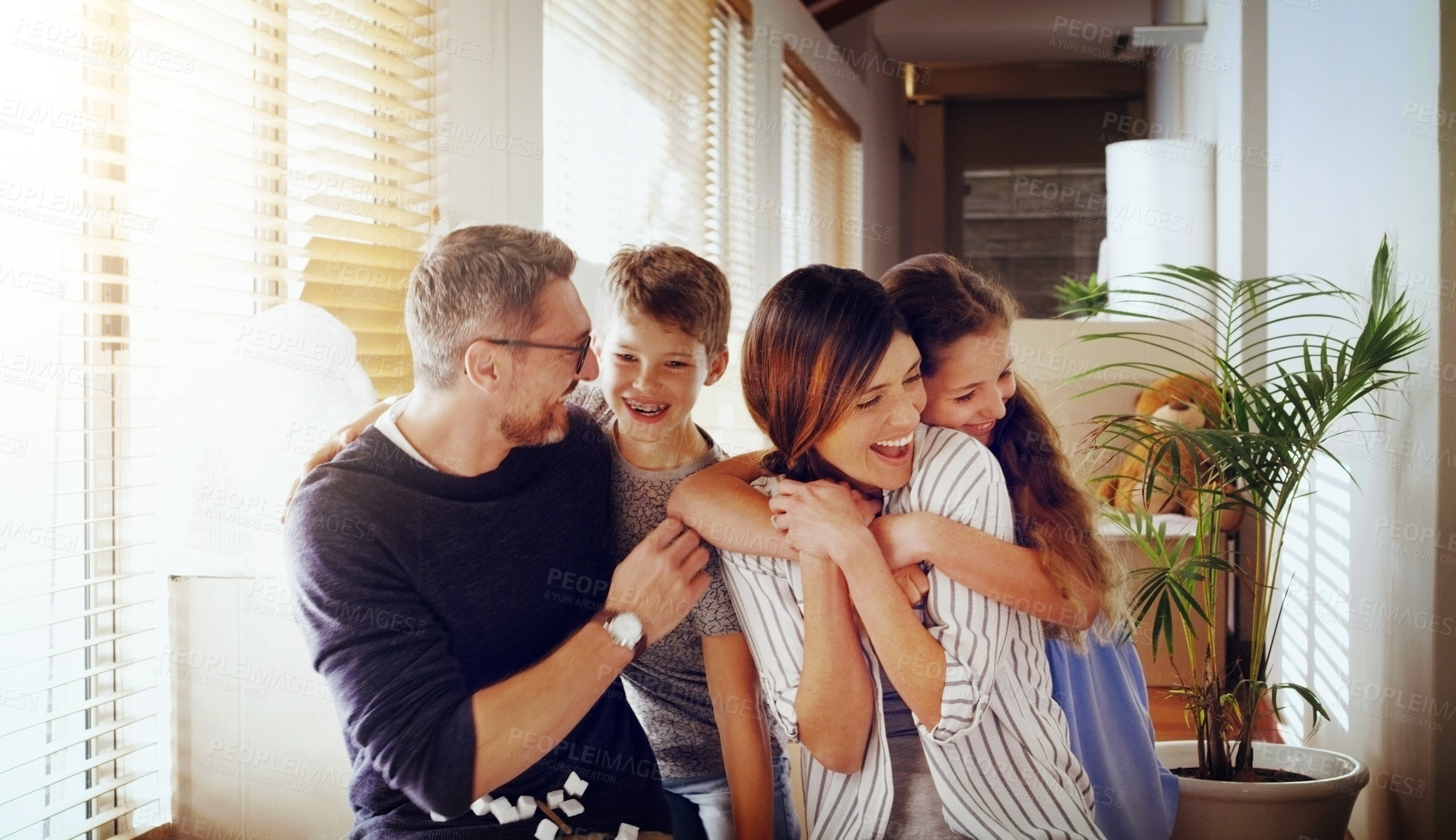 Buy stock photo Happy, love and family in their new home, moving and loving with embrace, laughing and cheerful together. Parents, mother and father with kids, children and siblings in an apartment and milestone