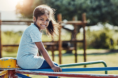 Buy stock photo Cropped portrait of an adorable little girl playing on a merry-go-round at the park