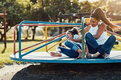 Buy stock photo Mother with daughter laughing, together on roundabout at park and playing with fun outdoor. Love, care and bonding with family happiness, woman and girl enjoying time at playground with freedom