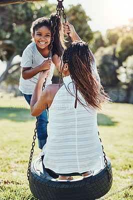 Buy stock photo Mother with daughter on swing at park, playing together with happiness and fun outdoor. Love, care and bonding with happy family in nature, woman and girl enjoying time at playground with freedom