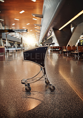 Buy stock photo Full length shot of an empty trolley in an airport