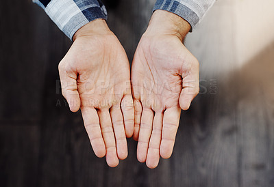 Buy stock photo High angle shot of an unrecognizable person's open hands shown against a dark background