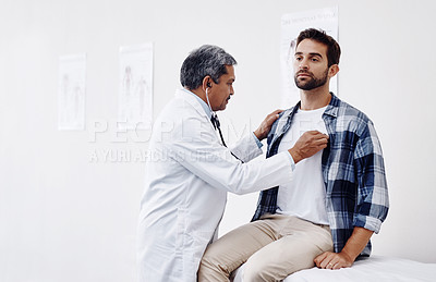 Buy stock photo Cropped shot of a mature male doctor and patient having a discussion in the doctor's office during a checkup
