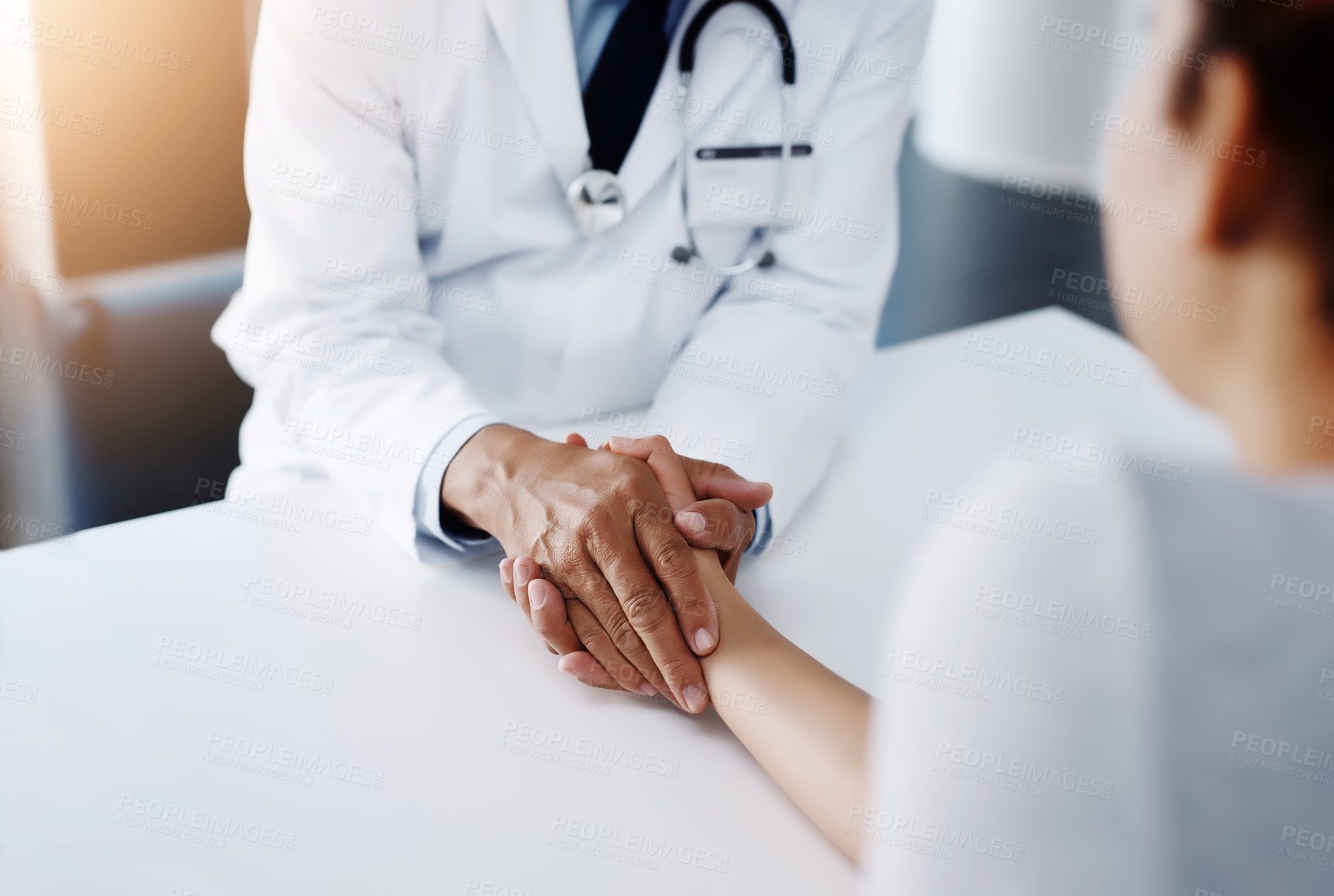 Buy stock photo Cropped shot of an unrecognizable doctor holding a patient's hand to comfort them and make them feel at ease