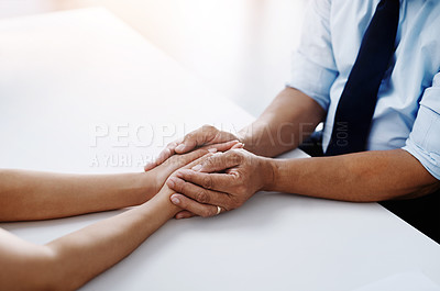 Buy stock photo Cropped shot of an unrecognizable doctor holding a patient's hand to comfort them and make them feel at ease