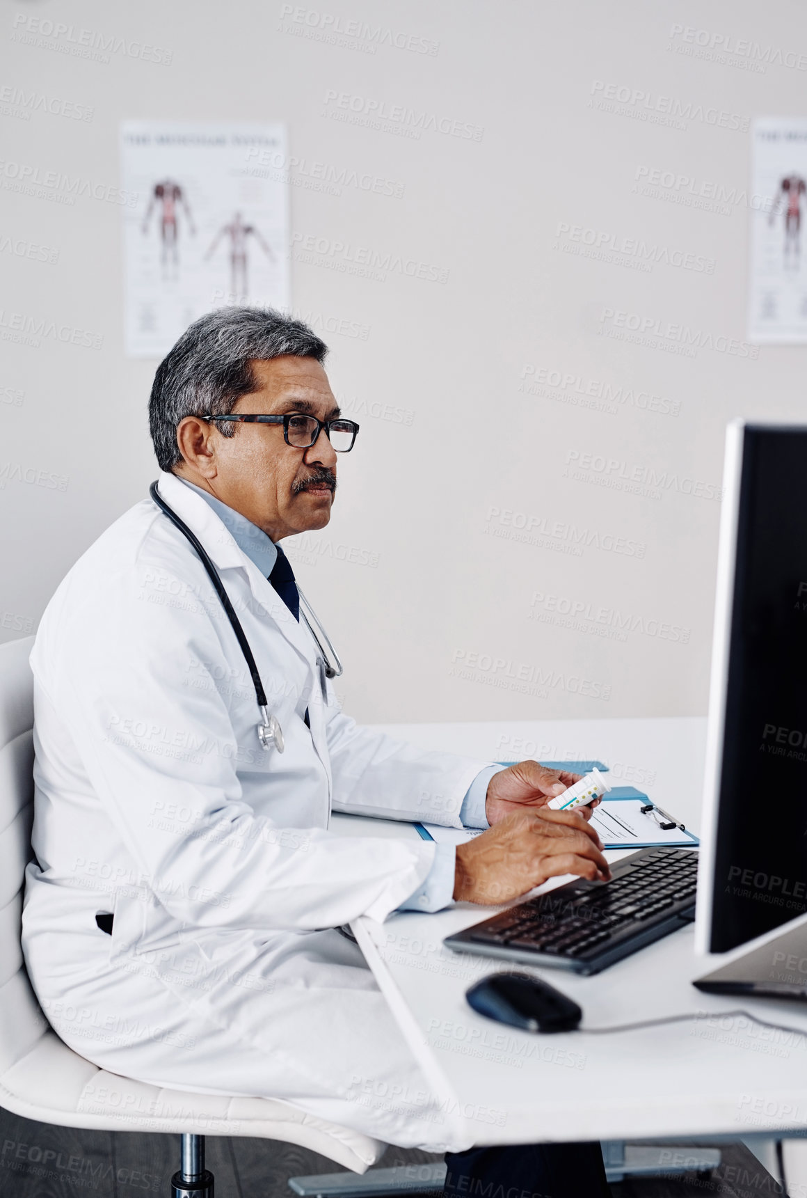 Buy stock photo Mature man, doctor and office on computer with pills for patient records, report and schedule. Male person, hospital and folder or documents for information with telehealth and prescription at clinic