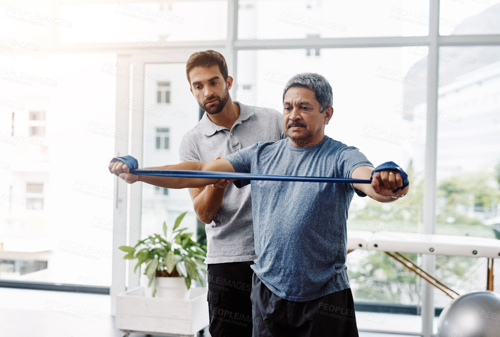 Buy stock photo Physiotherapy, stretching and band with old man and doctor for training, rehabilitation and injury. Medical, healing and healthcare with expert and patient for consulting, help and fitness