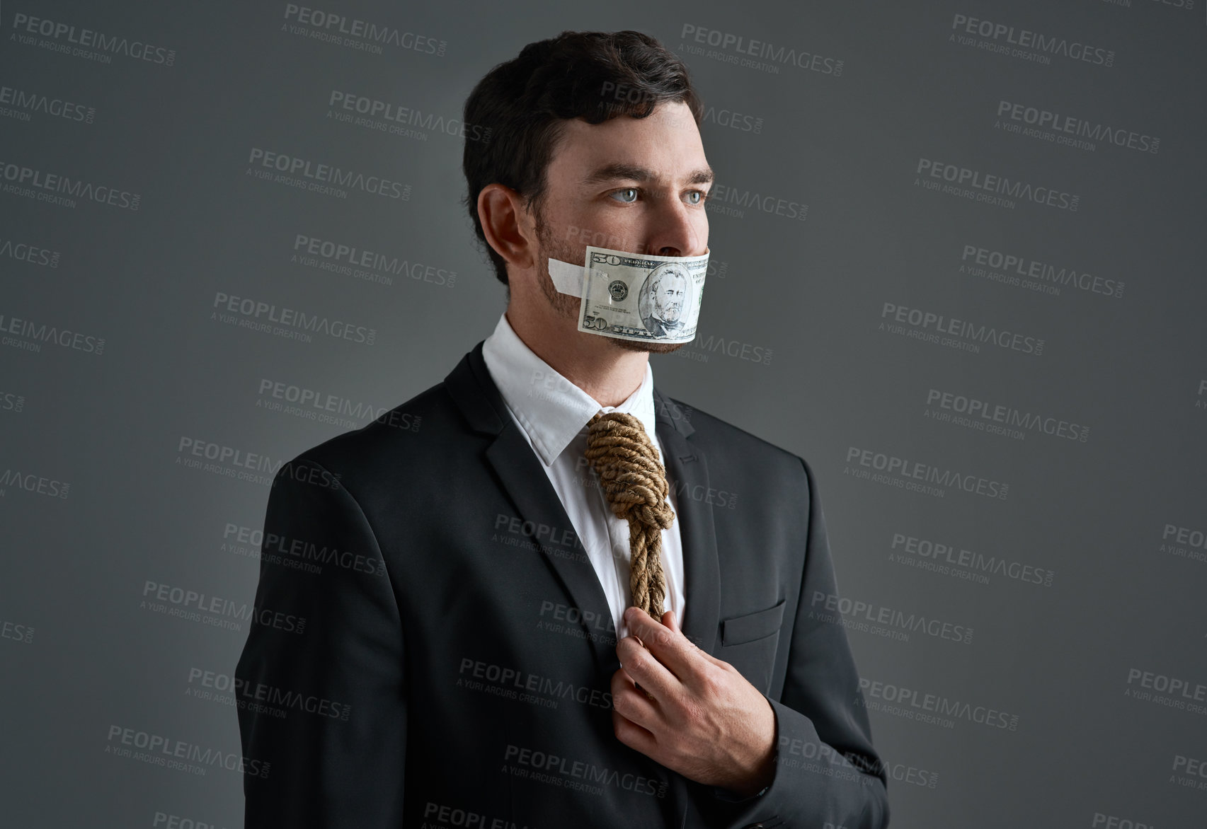 Buy stock photo Businessman, money gag and noose tie with corporate bribe, finance crime and silence payment. Model, metaphor and corrupt cash with financial bondage, fraud or illegal scam on gray studio background