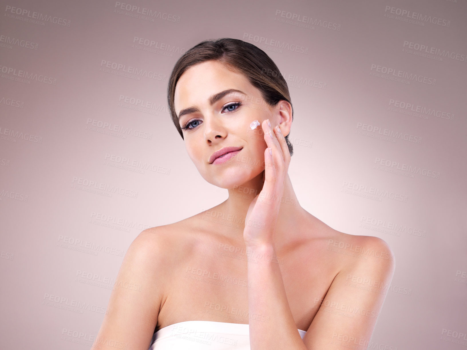 Buy stock photo Face cream, woman and portrait for beauty in studio on pink background with foundation, glow or natural shine. Facial lotion, model or elegant person with cosmetics, skincare or vitamin c results