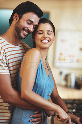 Buy stock photo Man, woman and hug with cooking in kitchen, smile and care with diet, health and prepare lunch in home. Indian people, happy couple and embrace with connection, love and meal prep for dinner in house