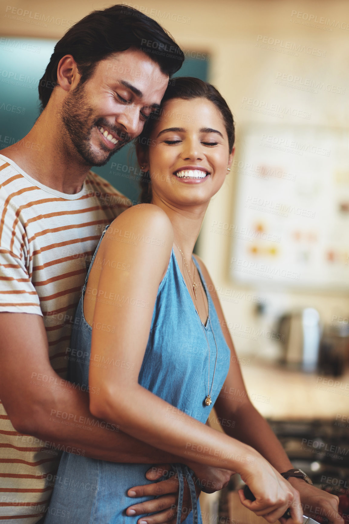 Buy stock photo Man, woman and hug with cooking in kitchen, smile and care with diet, health and prepare lunch in home. Indian people, happy couple and embrace with connection, love and meal prep for dinner in house