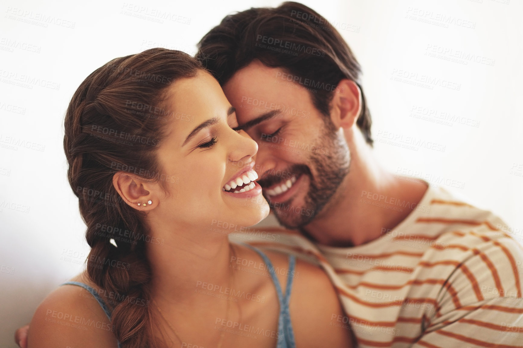 Buy stock photo Smile, couple and kiss in home with love for relationship commitment, affection and compassion with care. Man, woman and embrace together in house with soul connection, joy and romance with bonding.