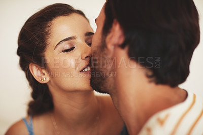 Buy stock photo Shot of an affectionate young couple bonding at home
