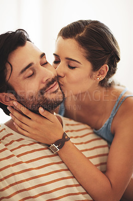 Buy stock photo Couple, love and cheek kiss in home for relationship trust, romantic moment and bonding together. Happy man, woman and kissing face for kindness with care, support and loyalty for healthy marriage