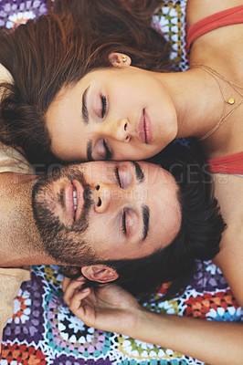 Buy stock photo High angle portrait of a happy young couple relaxing on a blanket outside