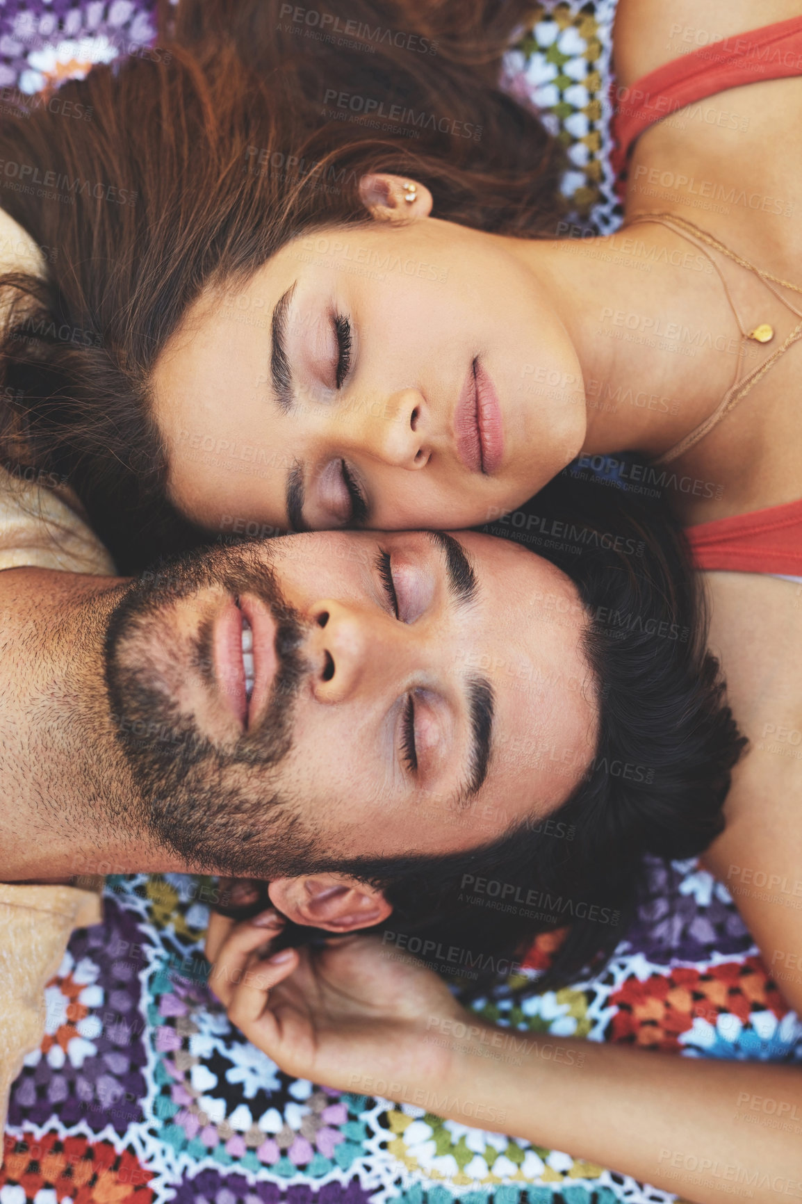 Buy stock photo High angle portrait of a happy young couple relaxing on a blanket outside